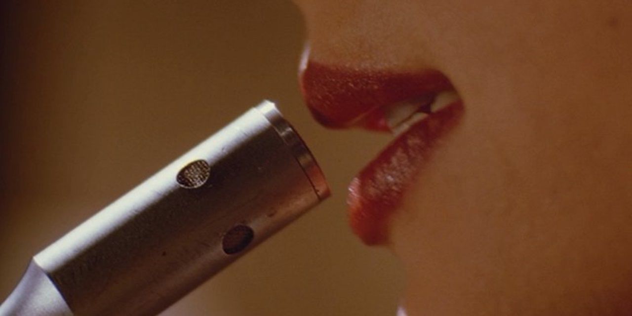 Mia Wallace speaks into a microphone in Pulp Fiction