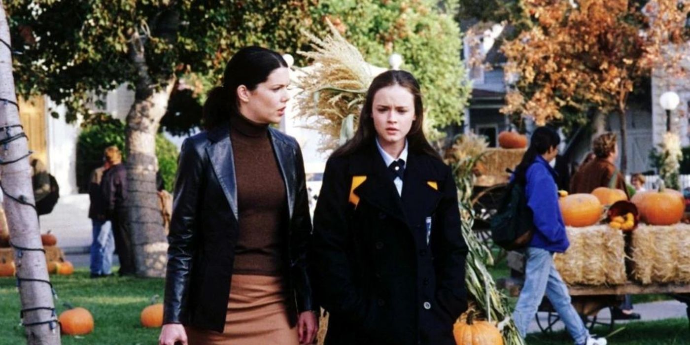 Rory and lorelai walk through Stars Hollow with pumpkins everywhere on Gilmore Girls