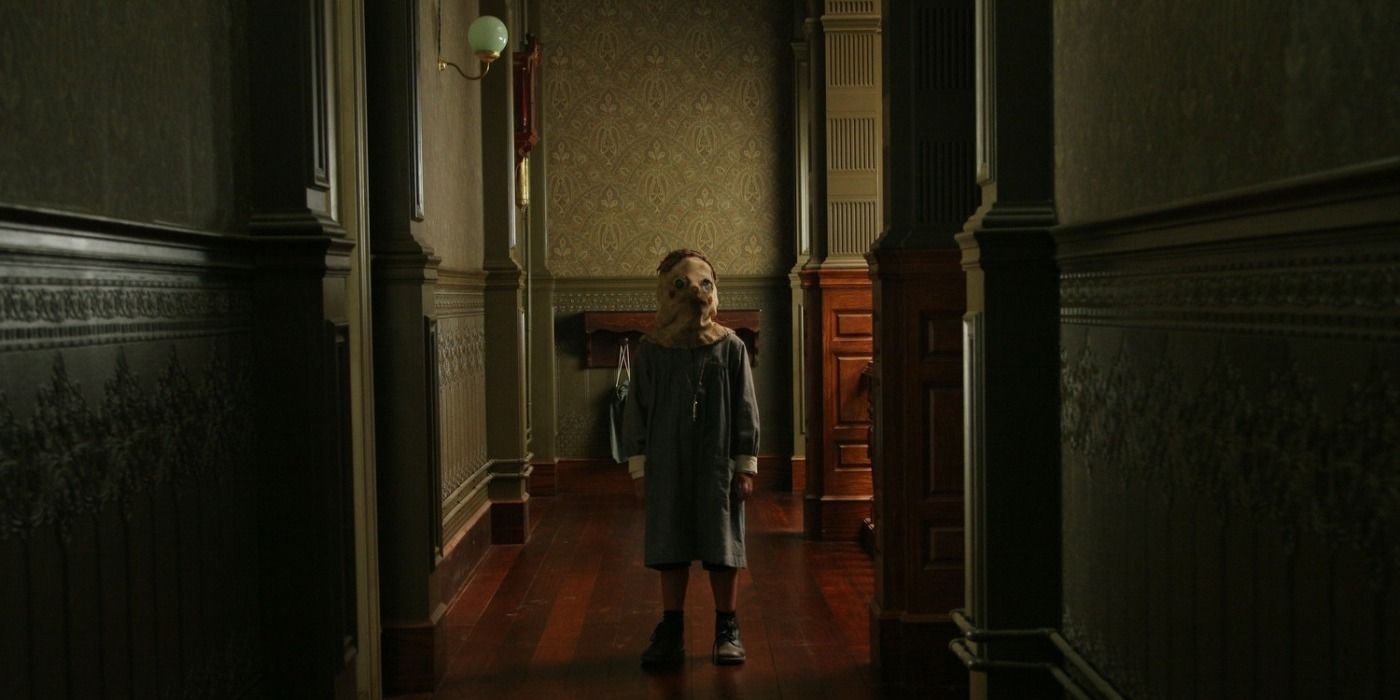 Tomas standing in the hallway in The Orphanage