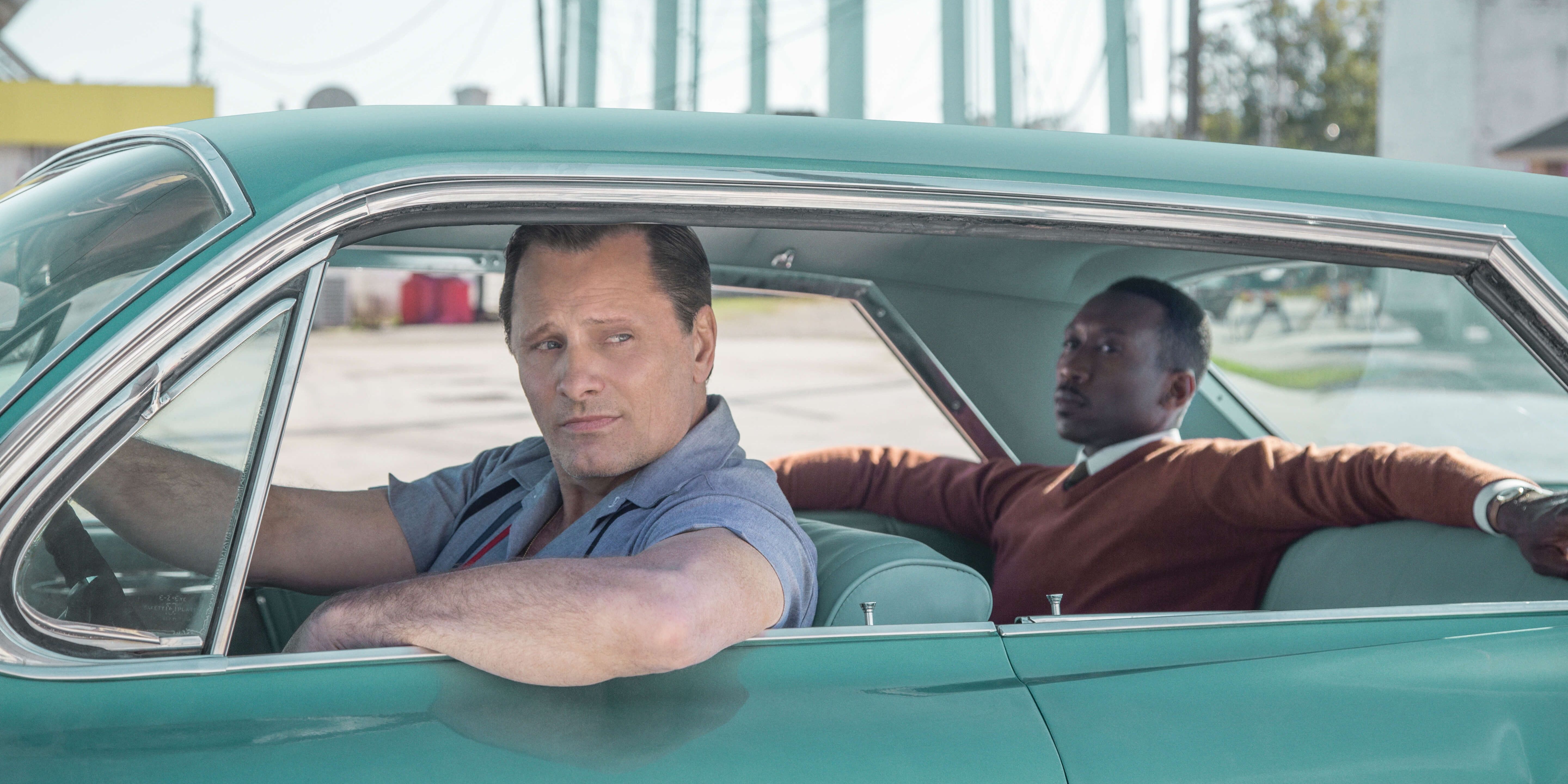 Viggo Mortensen and Mahershala Ali sitting inside the iconic turquoise Cadillac car in Green Book