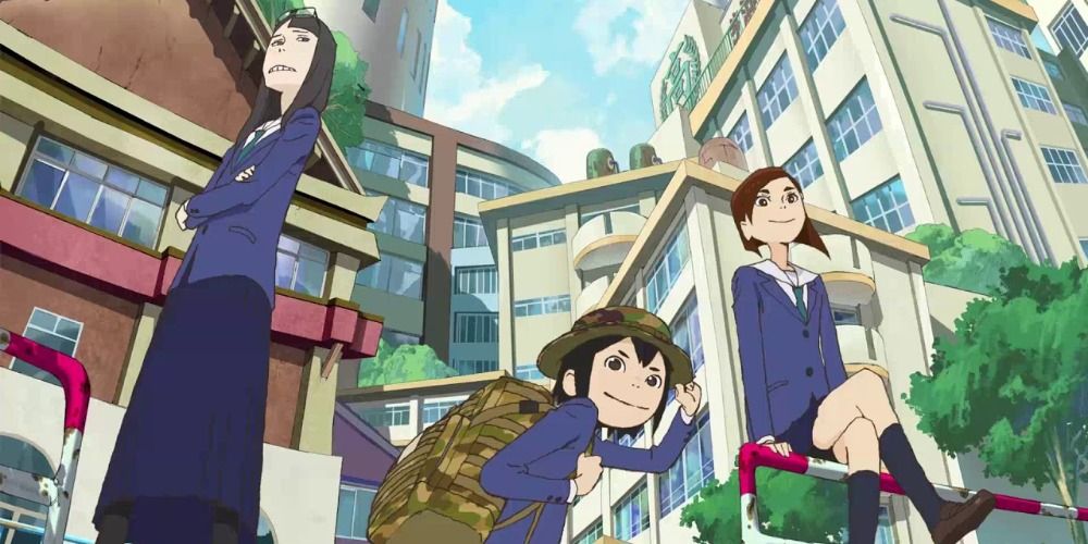 the three main characters of Keep Your Hands Off Eizouken posing in the middle of the street
