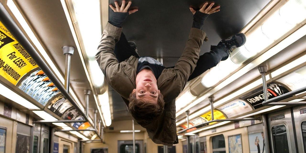 An image of Peter Parker crawling on the ceiling on a subway in Amazing Spider Man
