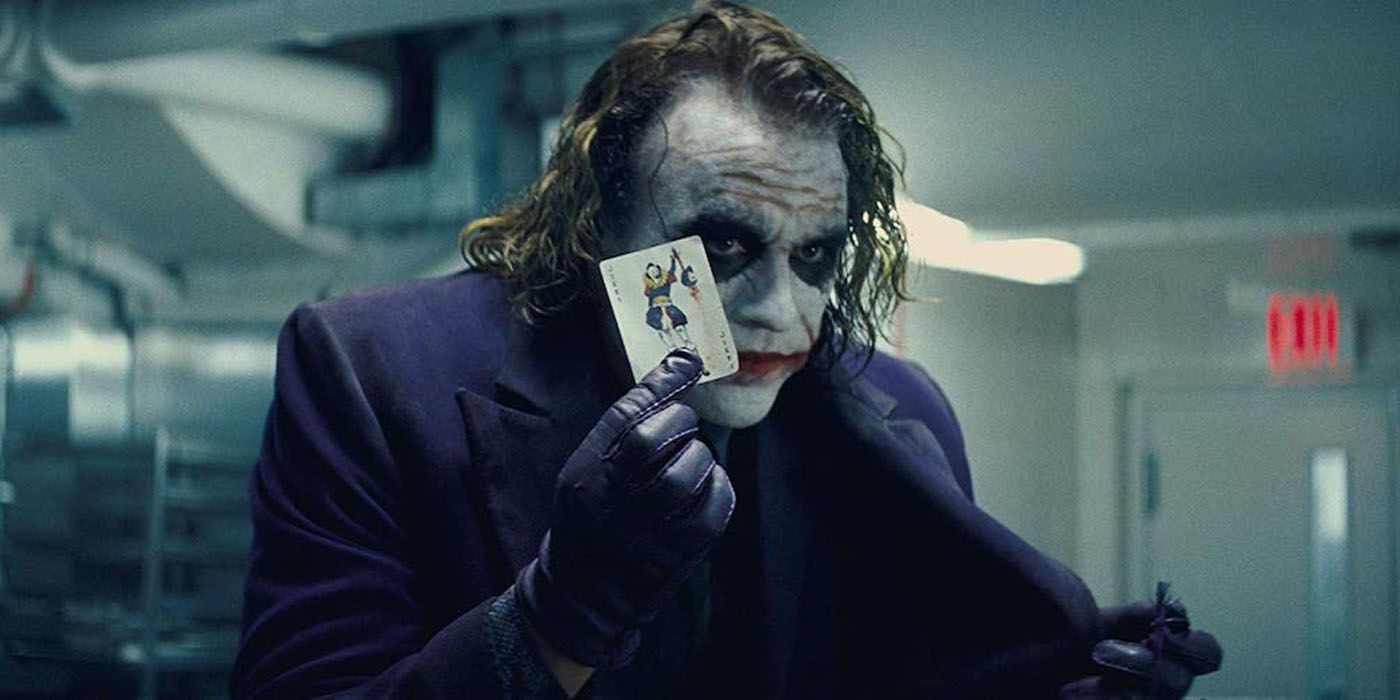 Joker holding up a playing card in Dark Knight 1