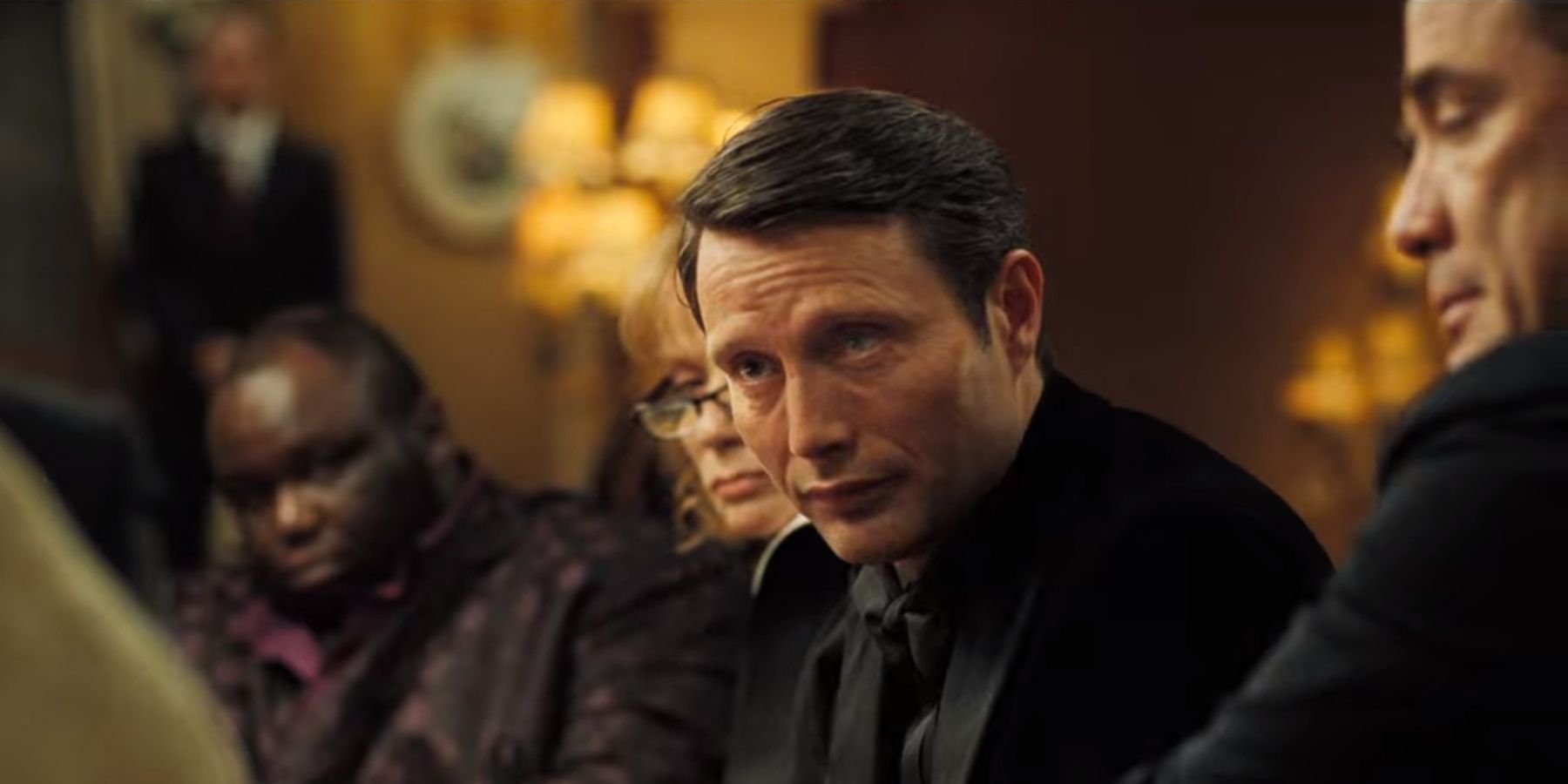 Le Chiffre at the poker table looking annoyed in Casino Royale