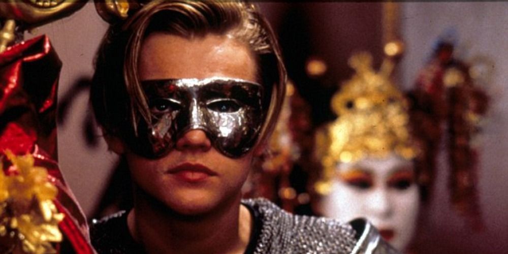 An image of Romeo wearing a costume and mask in the 1996 movie