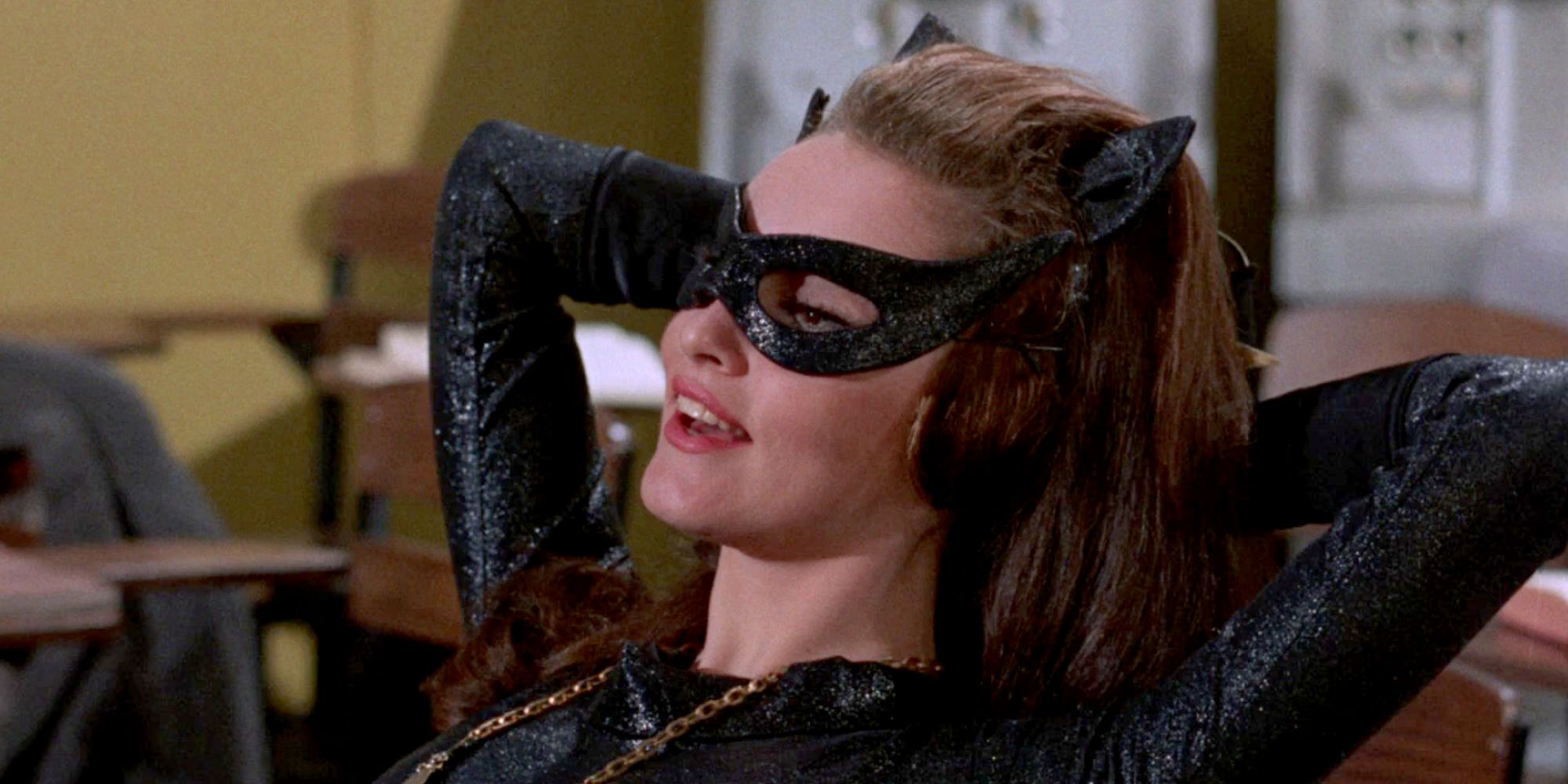 Julie Newmar as Catwoman resting in a chair in Batman 66