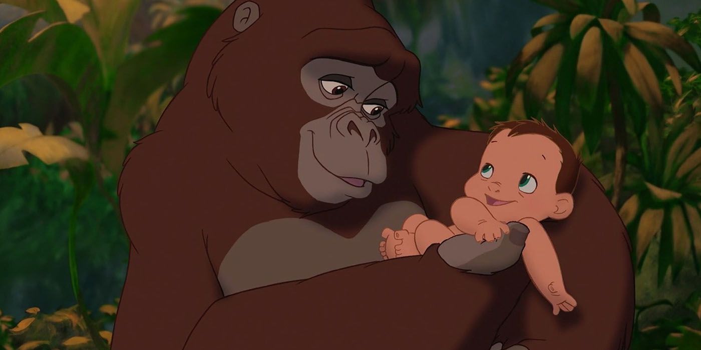 Kala smiles and holds baby Tarzan