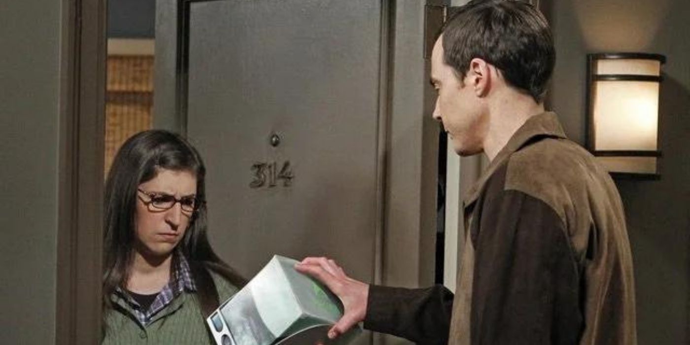 Sheldon gives something to Amy at her door on TBBT