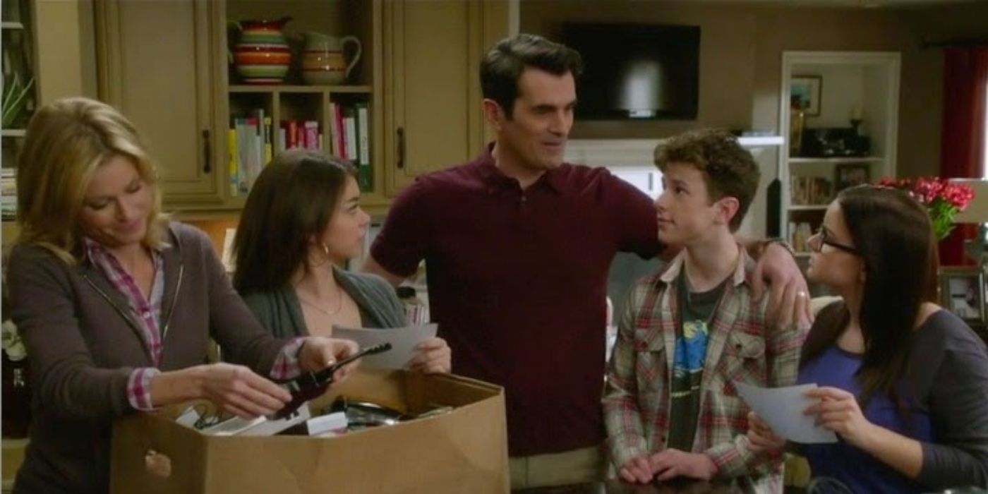 The Dunphys huddled around an old family box on Modern Family