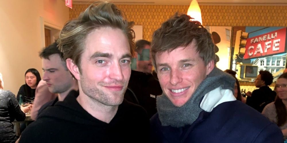 An image of Eddie Redmayne and Robert Pattinson smiling together