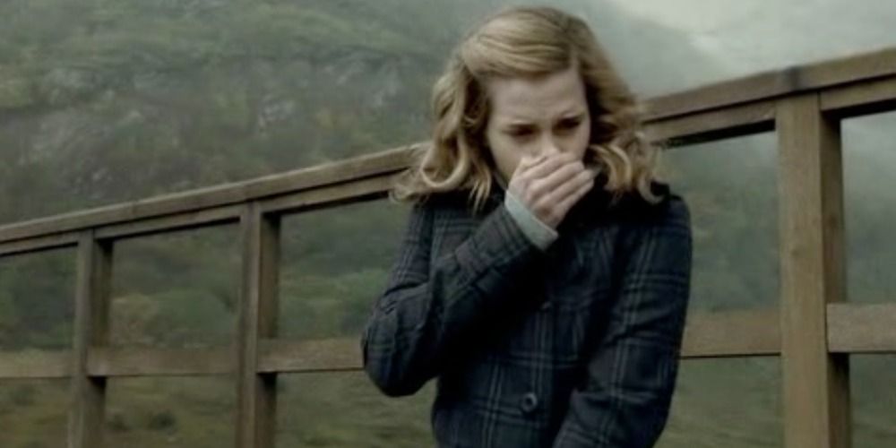 An image of Hermione speaking into her hand in Harry Potter
