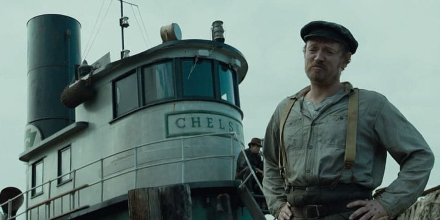 Captain Mike stands in front of his tugboat in The Curious Case of Benjamin Button