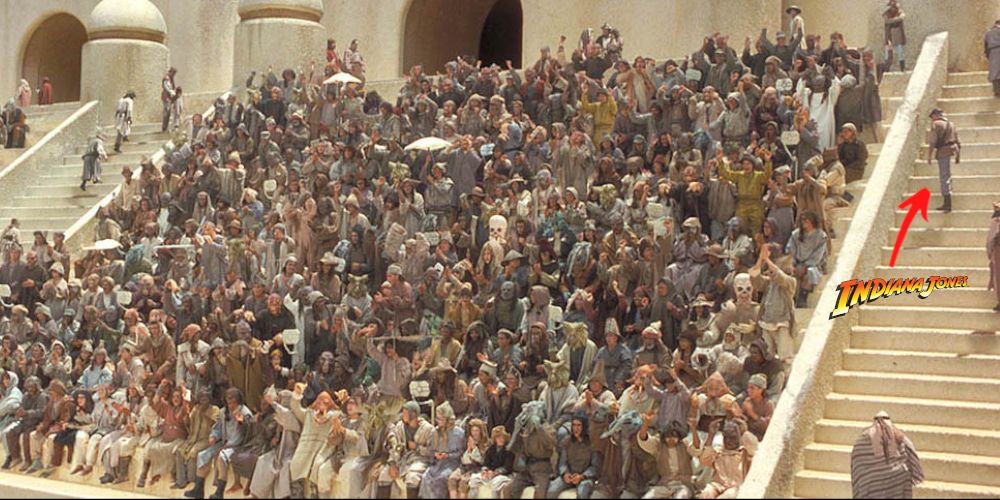 A character dressed similarly to indiana jones walks up the steps at the boonta eve podcast in star wars episode 1 the phantom menace